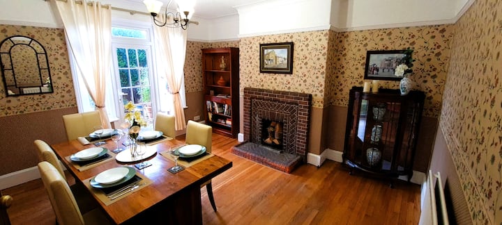 Vintage dining room with fireplace inside the Fenham short-let home